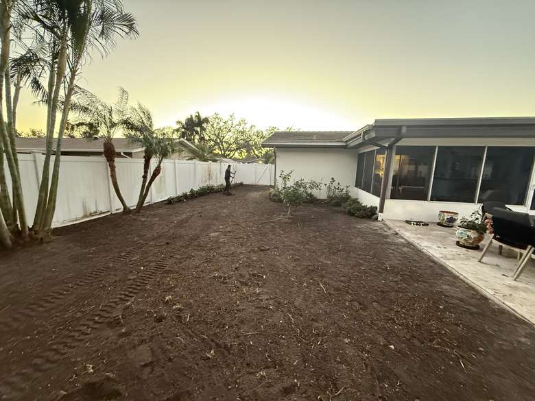 Cleared and graded backyard at sunset, ready for sod